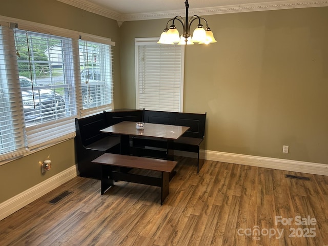 259 Oakland Heights Rd, Forest City, NC 28043 - dining area featuring a chandelier, baseboards, ornamental molding, and wood finished floors