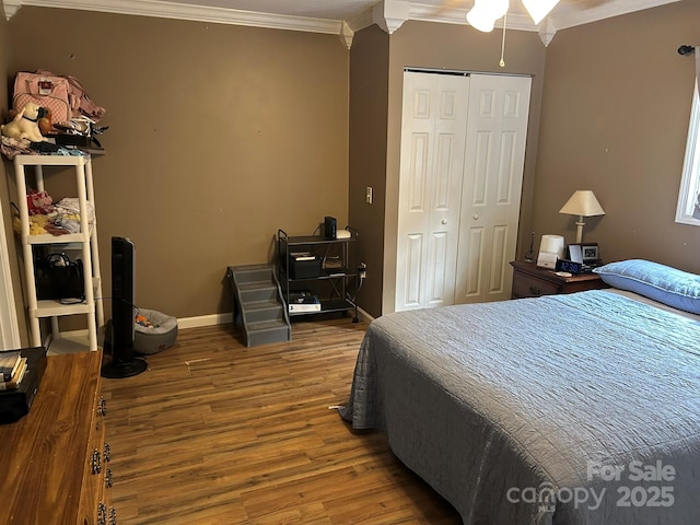 259 Oakland Heights Rd, Forest City, NC 28043 - bedroom featuring crown molding, wood finished floors, a closet, and baseboards