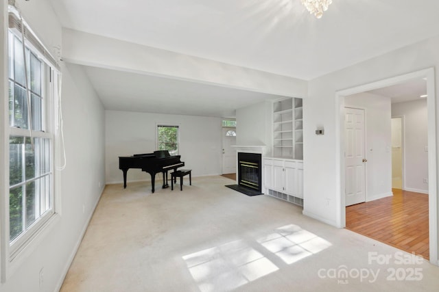 124 Hilltop Rd, Black Mountain, NC 28711 - living area with a glass covered fireplace, baseboards, light colored carpet, and built in features