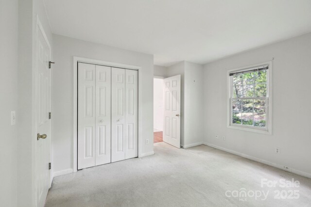 124 Hilltop Rd, Black Mountain, NC 28711 - unfurnished bedroom with baseboards, carpet floors, and a closet