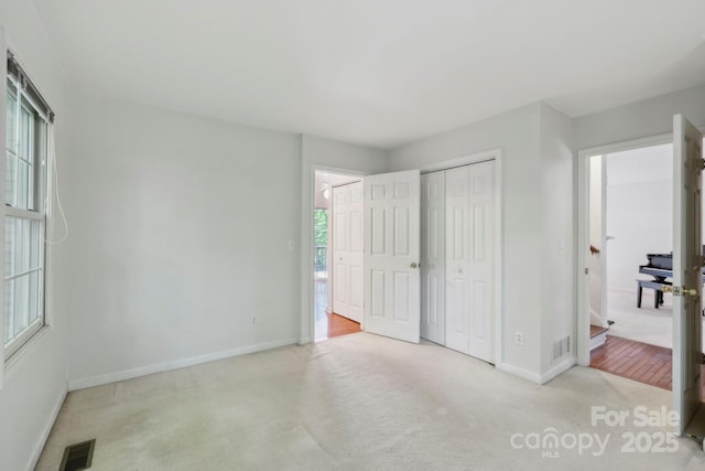 124 Hilltop Rd, Black Mountain, NC 28711 - unfurnished bedroom featuring baseboards, carpet floors, and a closet