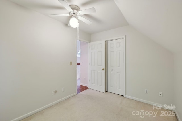 124 Hilltop Rd, Black Mountain, NC 28711 - unfurnished bedroom with carpet floors, baseboards, a closet, lofted ceiling, and a ceiling fan