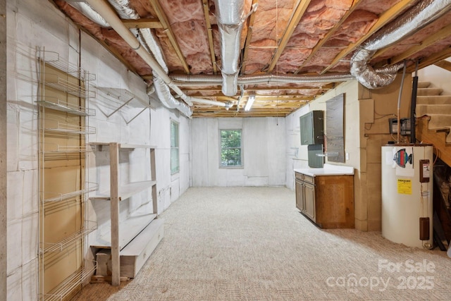 124 Hilltop Rd, Black Mountain, NC 28711 - below grade area featuring gas water heater, stairs, and light carpet