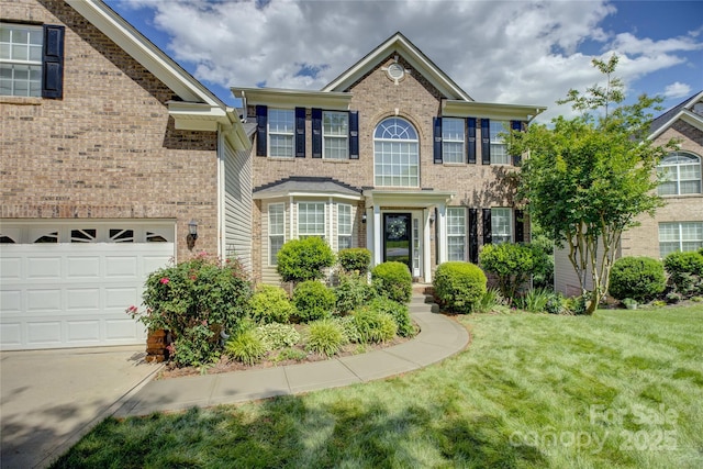 12125 Mountainside Ln, Charlotte, NC 28278 - view of front of house featuring a front yard, brick siding, and a garage