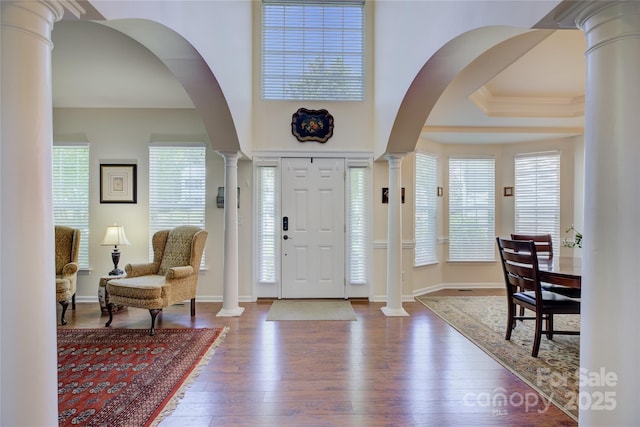 12125 Mountainside Ln, Charlotte, NC 28278 - foyer entrance featuring ornate columns, dark wood-style floors, and healthy amount of natural light