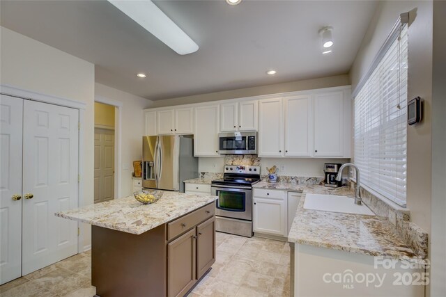 12125 Mountainside Ln, Charlotte, NC 28278 - kitchen with stainless steel appliances, a sink, white cabinets, and recessed lighting