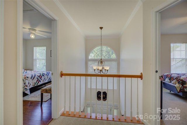 12125 Mountainside Ln, Charlotte, NC 28278 - hall featuring a chandelier, crown molding, healthy amount of natural light, and baseboards