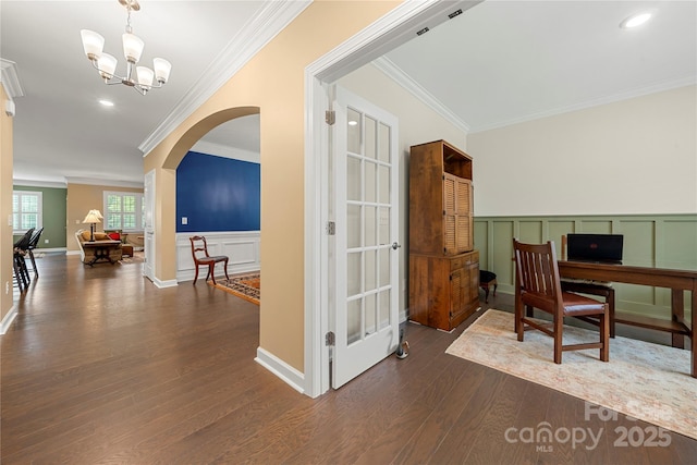 17028 River Race Dr, Huntersville, NC 28078 - home office with crown molding, a decorative wall, dark wood-type flooring, a chandelier, and arched walkways