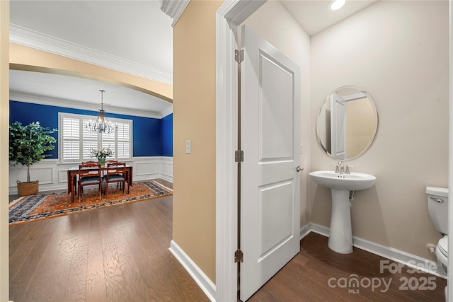 17028 River Race Dr, Huntersville, NC 28078 - bathroom with toilet, wood finished floors, a chandelier, wainscoting, and crown molding