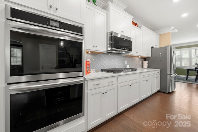 17028 River Race Dr, Huntersville, NC 28078 - kitchen featuring stainless steel appliances, dark wood-style flooring, light countertops, white cabinets, and decorative backsplash