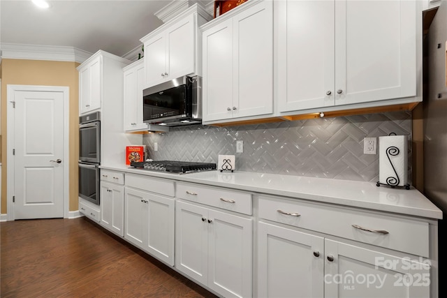 17028 River Race Dr, Huntersville, NC 28078 - kitchen featuring appliances with stainless steel finishes, light countertops, white cabinets, backsplash, and crown molding