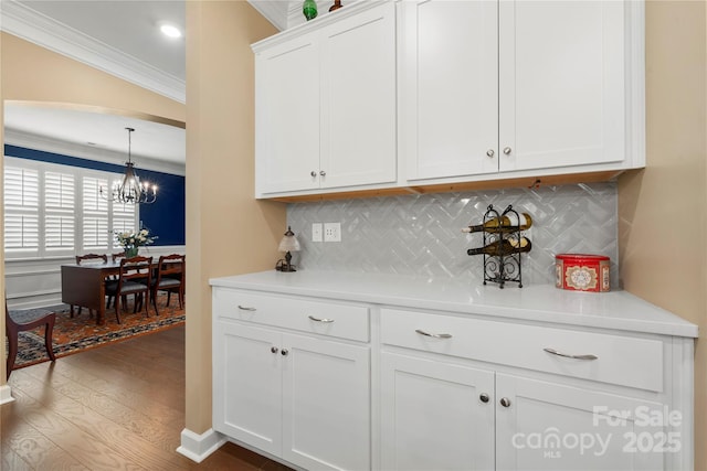 17028 River Race Dr, Huntersville, NC 28078 - kitchen featuring ornamental molding, wood finished floors, a chandelier, light countertops, and white cabinets