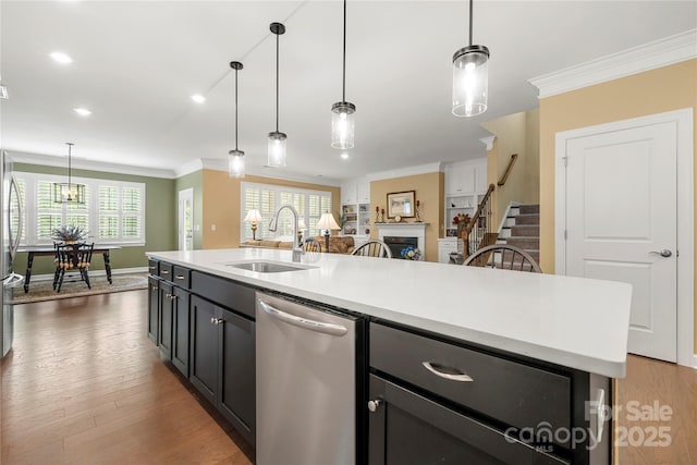 17028 River Race Dr, Huntersville, NC 28078 - kitchen featuring stainless steel dishwasher, a sink, ornamental molding, light countertops, and open floor plan