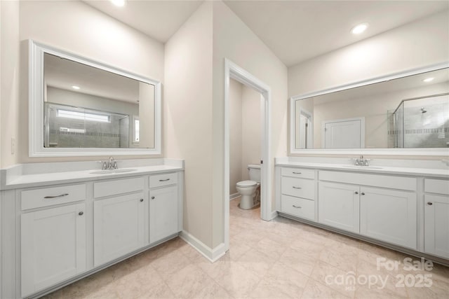 17028 River Race Dr, Huntersville, NC 28078 - full bathroom featuring a stall shower, two vanities, toilet, recessed lighting, and baseboards