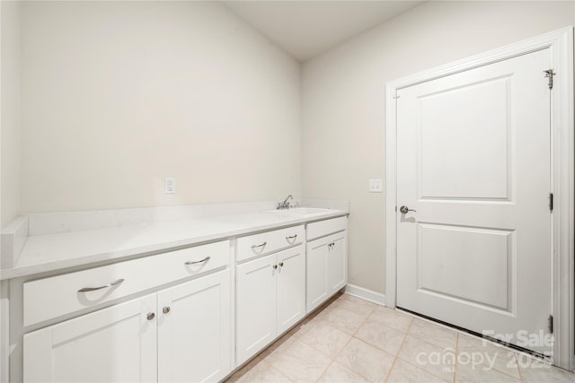 17028 River Race Dr, Huntersville, NC 28078 - laundry room with a sink, light tile patterned floors, and baseboards