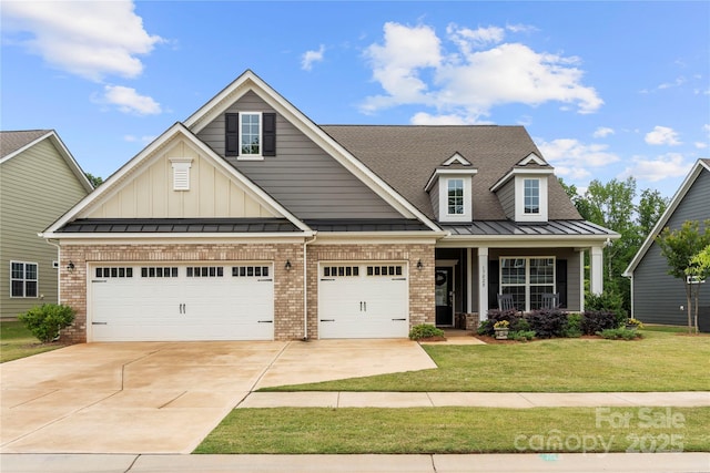 17028 River Race Dr, Huntersville, NC 28078 - craftsman-style home featuring driveway, a standing seam roof, a front lawn, brick siding, and a garage