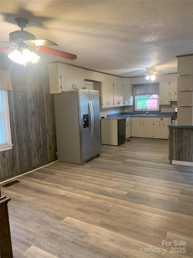 304 W Miller St, Jefferson, SC 29718 - kitchen featuring stainless steel fridge, ceiling fan, a textured ceiling, a sink, and wood walls