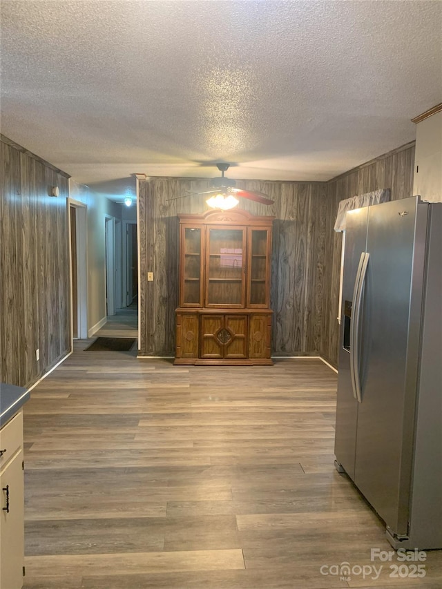 304 W Miller St, Jefferson, SC 29718 - interior space featuring a textured ceiling, wood walls, ceiling fan, and light wood-type flooring
