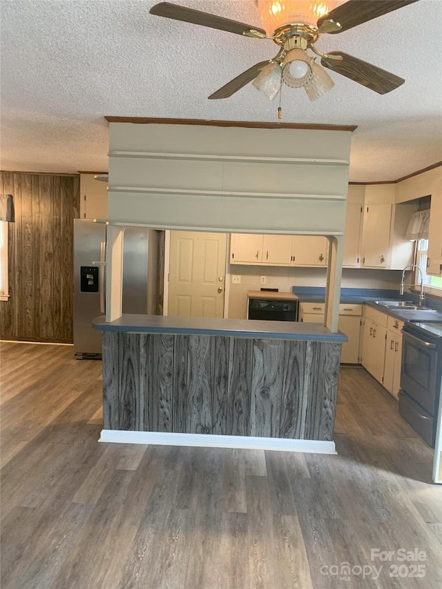 304 W Miller St, Jefferson, SC 29718 - kitchen featuring a sink, a textured ceiling, stainless steel refrigerator with ice dispenser, wood finished floors, and electric range