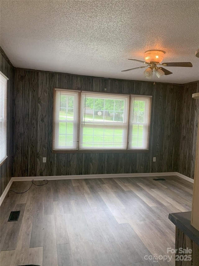 304 W Miller St, Jefferson, SC 29718 - spare room featuring a textured ceiling, a ceiling fan, wood finished floors, plenty of natural light, and baseboards
