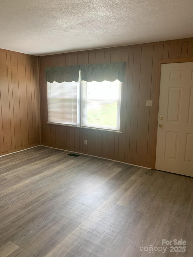304 W Miller St, Jefferson, SC 29718 - unfurnished room with a textured ceiling, wood finished floors, and wooden walls