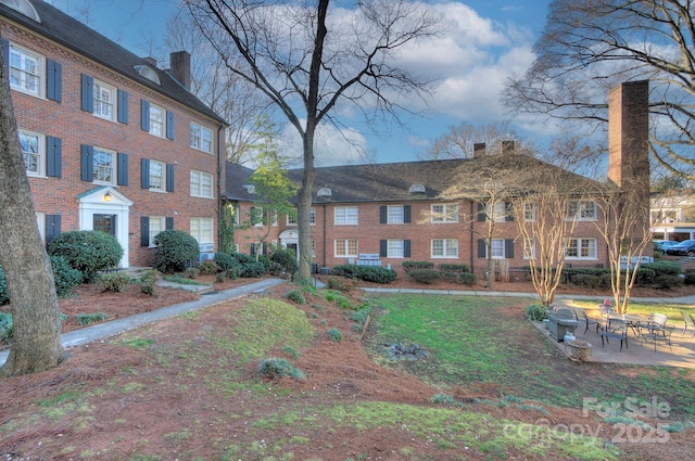 101 S Laurel Ave Unit 72A, Charlotte, NC 28207 - view of front of property with a chimney, brick siding, and a patio