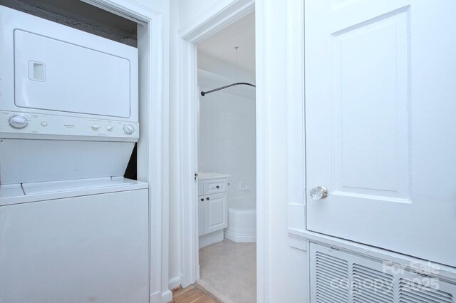 101 S Laurel Ave Unit 72A, Charlotte, NC 28207 - laundry area with estacked washer and dryer and light wood-style floors