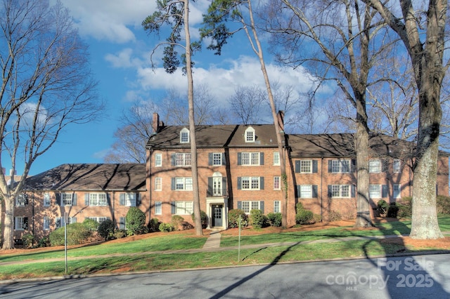 101 S Laurel Ave Unit 72A, Charlotte, NC 28207 - view of front facade with a chimney, a front lawn, and brick siding