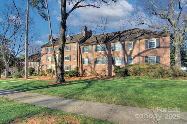 101 S Laurel Ave Unit 72A, Charlotte, NC 28207 - view of front of house with a chimney, brick siding, and a front lawn