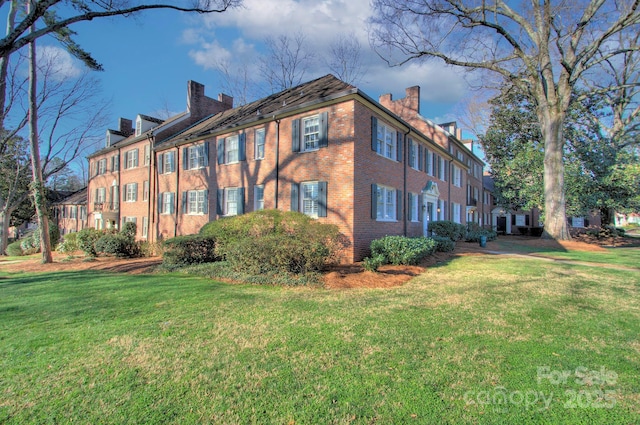 101 S Laurel Ave Unit 72A, Charlotte, NC 28207 - view of side of home featuring a chimney, a lawn, and brick siding