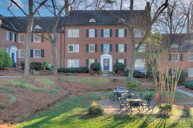 101 S Laurel Ave Unit 72A, Charlotte, NC 28207 - view of front of property with a chimney, a patio area, and brick siding