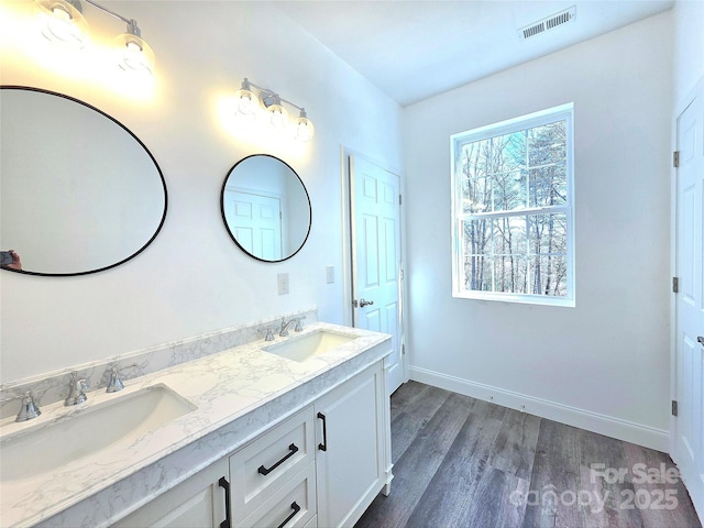 690 Settlers Trl, Mars Hill, NC 28754 - bathroom featuring double vanity, wood finished floors, and baseboards