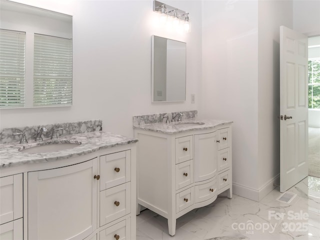690 Settlers Trl, Mars Hill, NC 28754 - bathroom with marble look tiles, two vanities, and baseboards