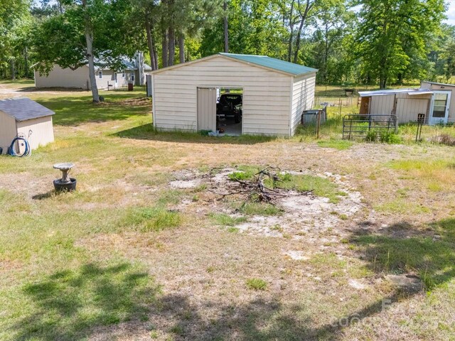 2675 Andrews Cir, Aiken, SC 29803 - view of yard featuring an outbuilding, view of wooded area, and a pole building