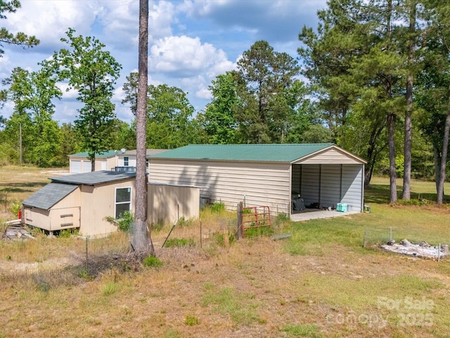 2675 Andrews Cir, Aiken, SC 29803 - view of outbuilding with a carport and view of wooded area