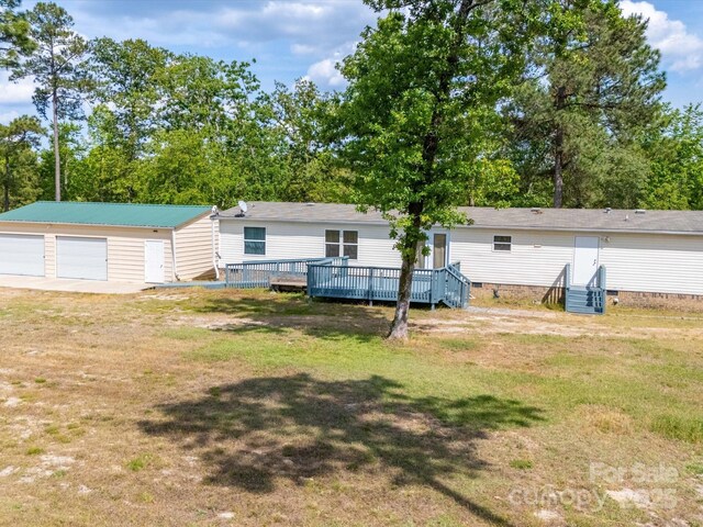 2675 Andrews Cir, Aiken, SC 29803 - back of property featuring crawl space, a garage, a yard, an outdoor structure, and a wooden deck