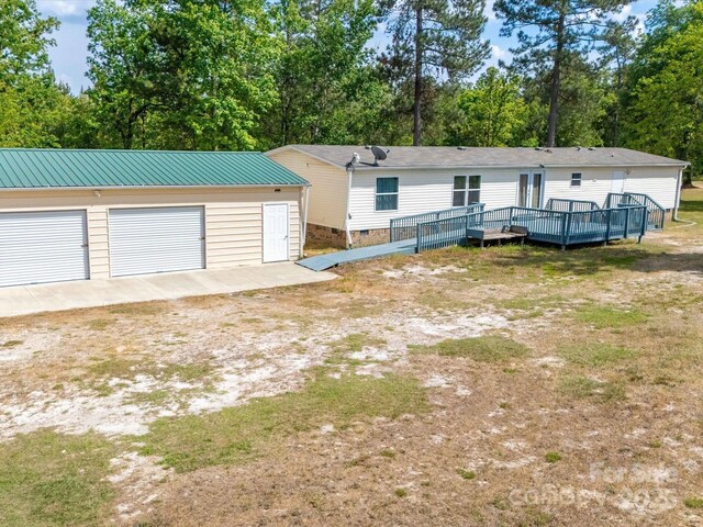 2675 Andrews Cir, Aiken, SC 29803 - view of front facade featuring a wooden deck, an outbuilding, crawl space, a garage, and view of wooded area