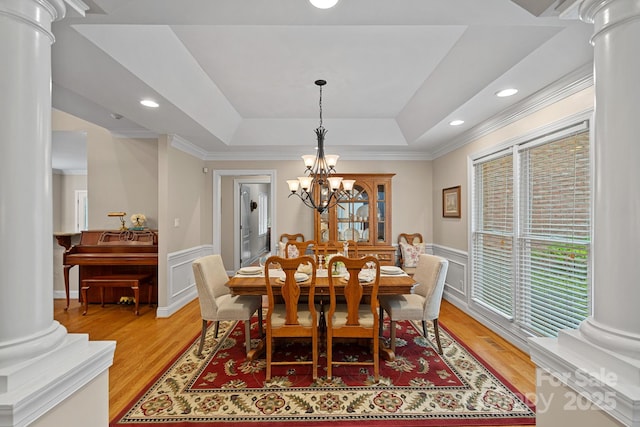 166 Pinnacle Shores Dr, Mooresville, NC 28117 - dining area with ornate columns, light wood finished floors, ornamental molding, wainscoting, and a chandelier