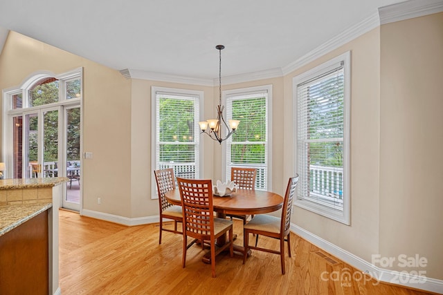 166 Pinnacle Shores Dr, Mooresville, NC 28117 - dining room with a chandelier, baseboards, light wood finished floors, plenty of natural light, and crown molding