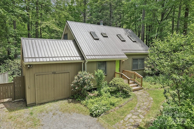 19 Reuben Branch Rd, Maggie Valley, NC 28751 - view of front facade with metal roof, fence, and a wooded view