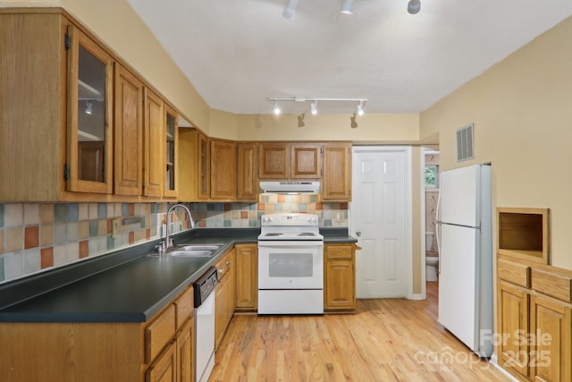 19 Reuben Branch Rd, Maggie Valley, NC 28751 - kitchen with white appliances, a sink, under cabinet range hood, dark countertops, and light wood finished floors