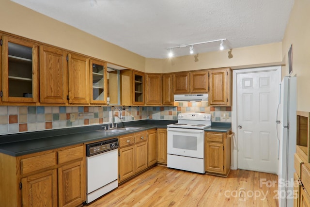 19 Reuben Branch Rd, Maggie Valley, NC 28751 - kitchen featuring white appliances, a sink, range hood, brown cabinets, and a textured ceiling