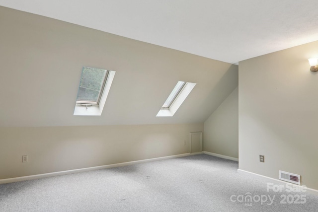 19 Reuben Branch Rd, Maggie Valley, NC 28751 - additional living space with a skylight, carpet, vaulted ceiling, baseboards, and healthy amount of natural light