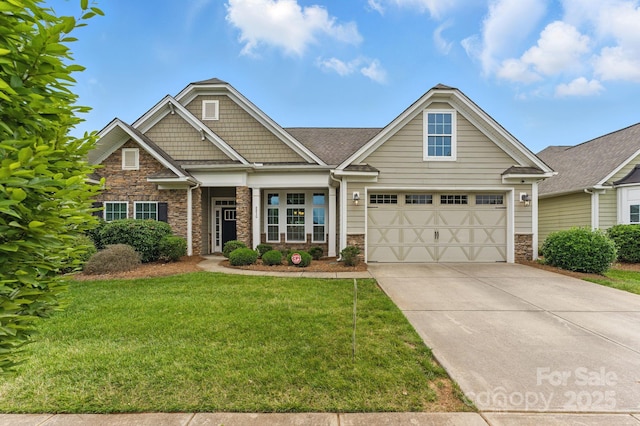 craftsman house featuring stone siding, driveway, a front yard, and a garage