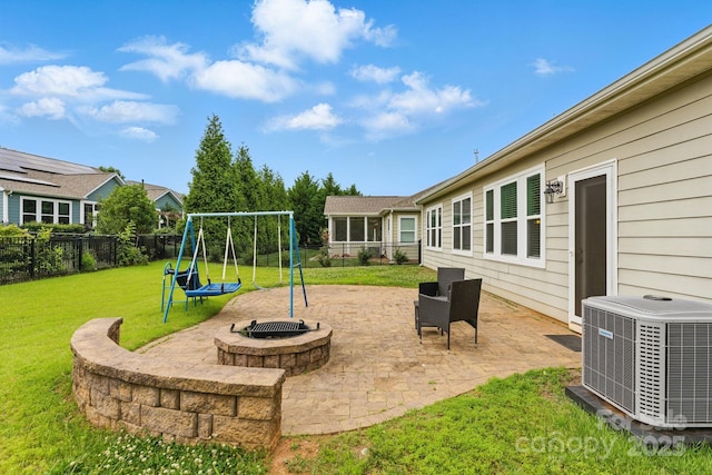 view of yard featuring central air condition unit, a playground, and a patio