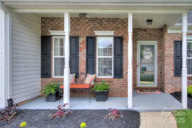 5748 Timbertop Ln, Charlotte, NC 28215 - view of exterior entry with a porch and brick siding