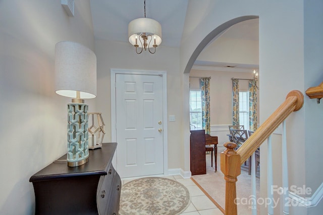 5748 Timbertop Ln, Charlotte, NC 28215 - entryway with arched walkways, light tile patterned flooring, a chandelier, baseboards, and ornamental molding