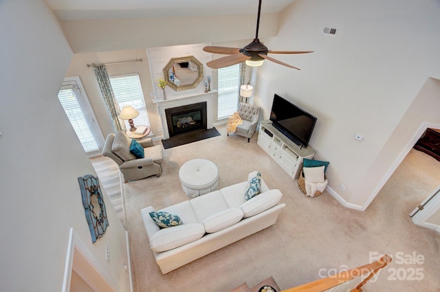 5748 Timbertop Ln, Charlotte, NC 28215 - carpeted living room with ceiling fan, baseboards, a fireplace with flush hearth, and vaulted ceiling