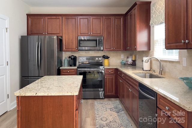 5748 Timbertop Ln, Charlotte, NC 28215 - kitchen featuring stainless steel appliances, a sink, light wood-type flooring, and light stone counters