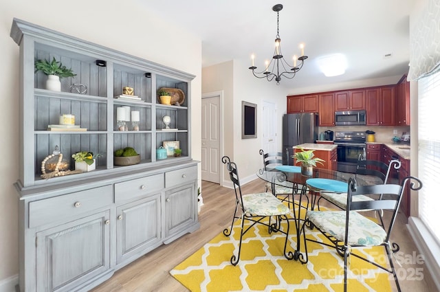 5748 Timbertop Ln, Charlotte, NC 28215 - dining room with a chandelier, light wood-type flooring, and baseboards